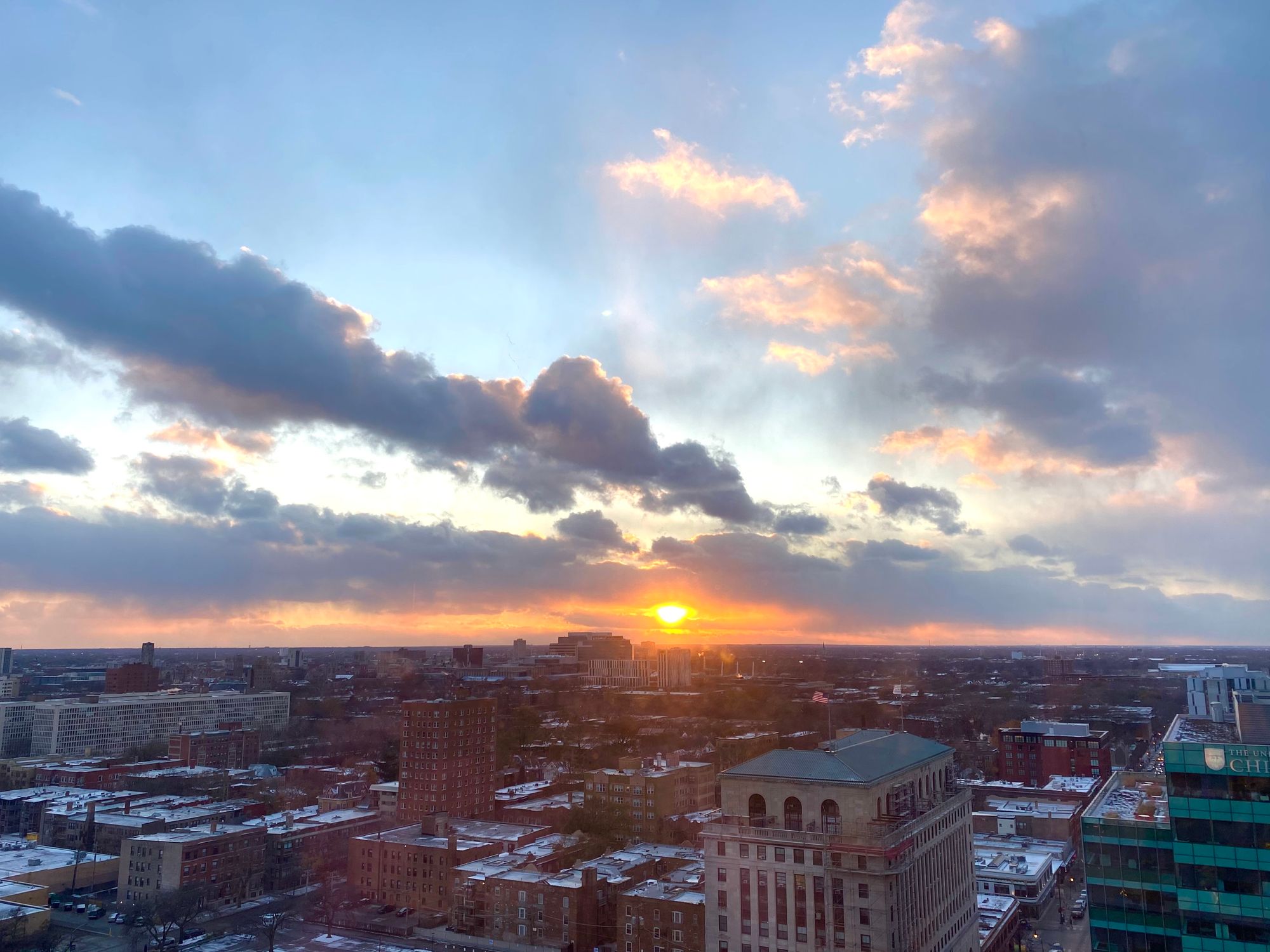 view of chicago looking west from hyde park. sunset behind the u chicago medical building